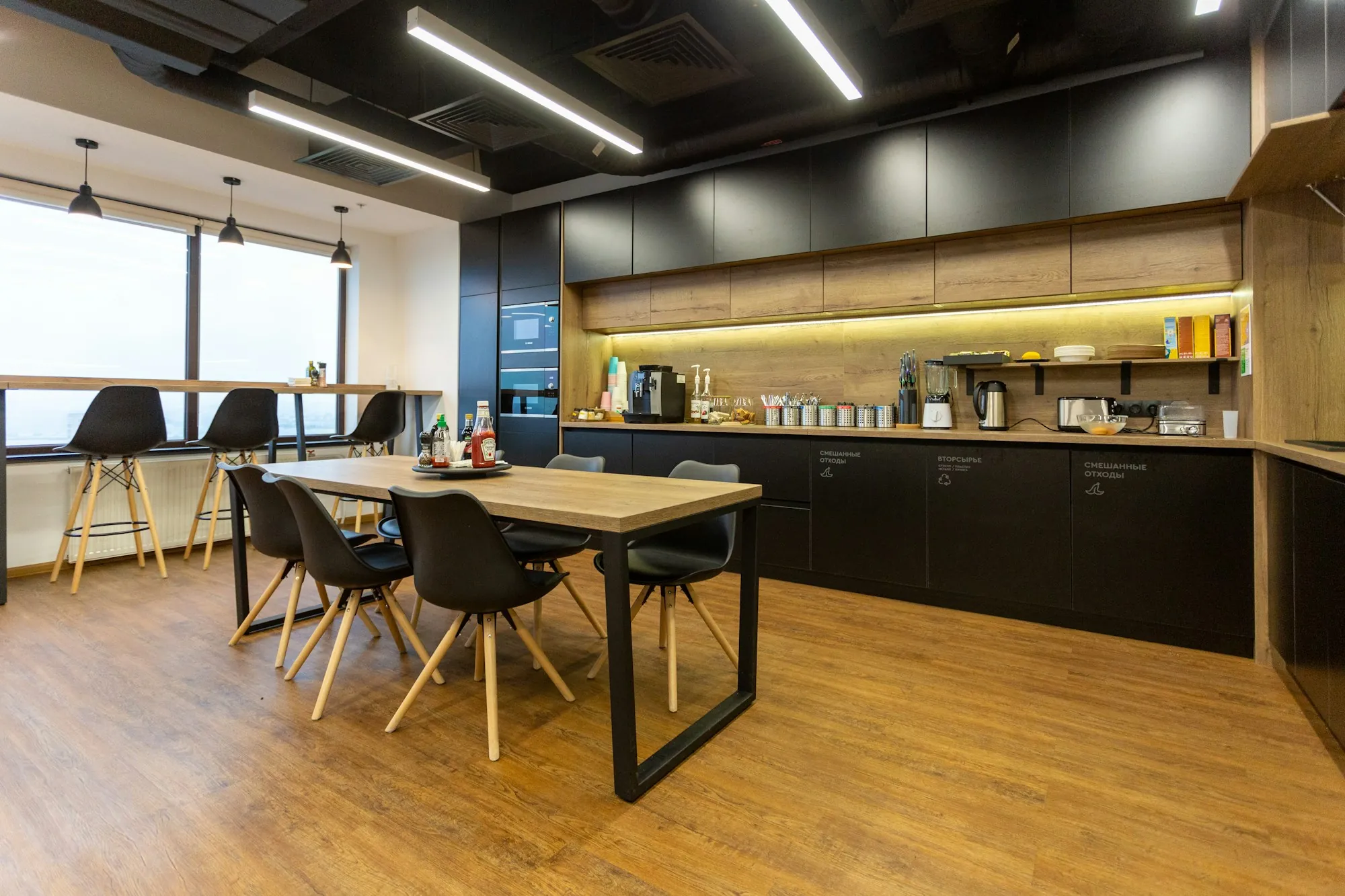 Office breakroom with a long table and kitchen