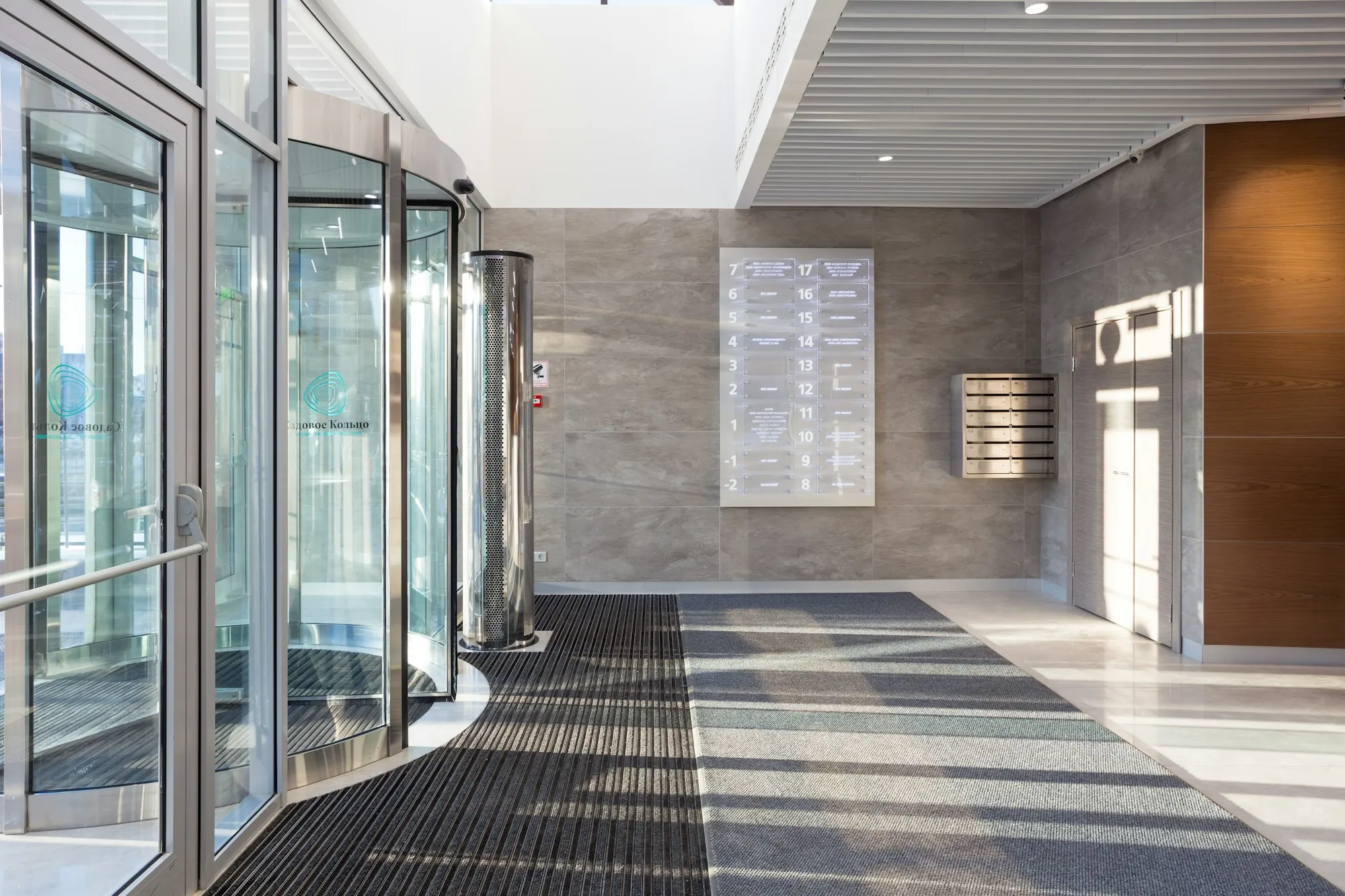 Building entrance with revolving doors and a walk-off mat
